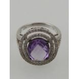 An 18 carat white gold, diamond and amethyst cluster ring,