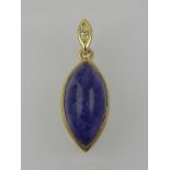 A yellow metal and lozenge cut tanzanite pendant,