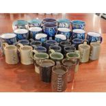 Lee Phillips Devon pottery mugs, having abstract decoration, to include mugs and jugs.
