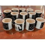 A collection of pottery mugs, decorated in black and white with animals.