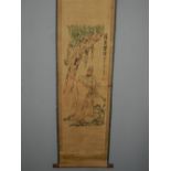 A Chinese scroll, polychrome printed with figures amongst a stylised landscape. W.