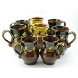 Hannah McAndrew slipware mugs, glazed in brown and yellow,