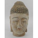A terracotta head of an East Asian god. H: 15cm