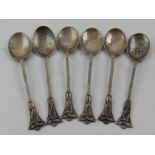In the Arts & Crafts style, six silver tea spoons, hallmarked London.