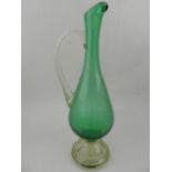 A 20th century Continental green and clear glass ewer, having turned handle on a circular base. H.