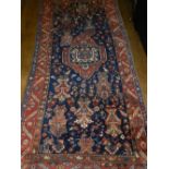 An early 20th century Persian blue ground Bakhtiar rug, having a central medallion,