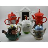 A collection of novelty tea pots.