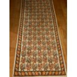 A cream ground Turkish runner, decorated with stylised flowers to centre, fringed. L.457cm W.