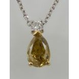 An unusual yellow gold mounted pear cut yellow diamond pendant, the stone of approx. 0.
