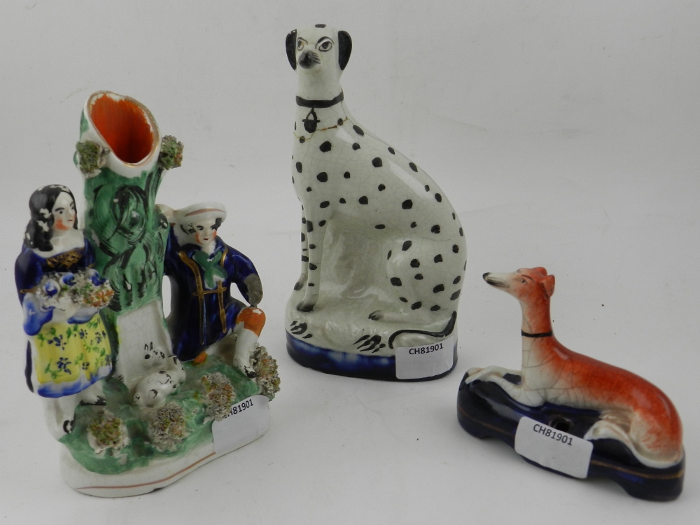 A collection of three Staffordshire figurines.