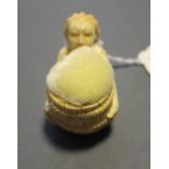 A Victorian style pin cushion modeled as a mermaid holding a barrel.