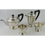 A silver four piece tea service, Birmingham 1937, the lid decorated with a diamond band,