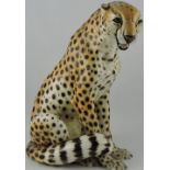 A vintage Ronzan Pottery leopard, seated with an open mouth and a fixed gaze, H. 39cm.