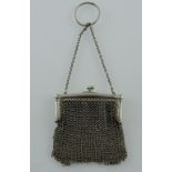 A white metal chain-link sovereign purse.