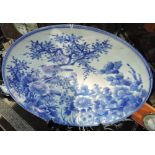 A large Chinese circular porcelain charger decorated with a bird among blossom,