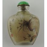 A Chinese interior painted snuff bottle, showing bamboo and flowers from a tuffet, H. 6cm.