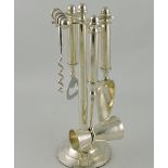 A chrome plated four-piece bar set on stand, comprising corkscrew, bottle opener,