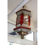 A 20th century Moorish style hexagonal lantern, with panels of opaque white and red glass.