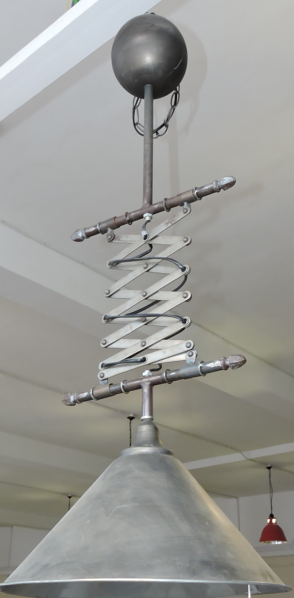 An industrial style metal rise and fall pendant light fitting