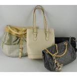 A cream leather bucket shaped handbag, with matching purse,