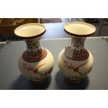 A pair of modern Chinese porcelain baluster vases, decorated with exotic birds among peonies.