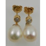 A pair of yellow metal, diamond, and pearl drop earrings, the diamonds of approx. 0.