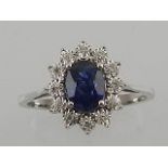 An 18ct white gold sapphire and diamond set cluster ring,