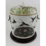 A Chinese porcelain twin-handled jar and cover, decorated with butterflies and flowers,
