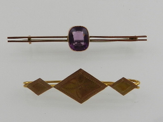 A 9 carat yellow gold bar brooch set with a cushion cut amethyst,