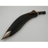 A Kukri, having engraved blade and leather scabbard.