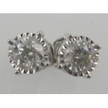 A pair of 18ct white gold and diamond set ear studs, in openwork mounts.