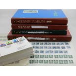 A collection of five stamp albums, including stamps from The United States, France,