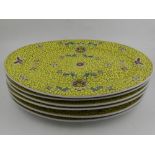 A set of six Chinese yellow ground glazed serving dishes, decorated with flowers and scrolls,