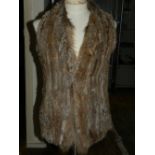 A ladies brown rabbit fur vest.