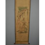 A Chinese scroll, polychrome printed with figures amongst a stylised landscape. W.48cm