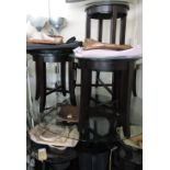 An ebonised circular glass topped table, the bevelled top on square tapering legs, D.