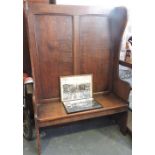 A 17th century style oak panel back settle,