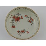 A late 19th century Chinese saucer, decorated with iron red floral sprigs on a white ground, D.