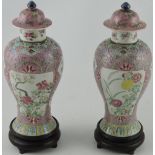 A pair of 19th century Chinese baluster shaped lidded vases,