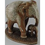 An early 20th century carved hardwood elephant with calf,