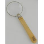 A Japanese Shibyama-style bone handled magnifying glass.