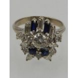 A white metal, diamond, and sapphire cluster ring, in the Art Deco taste,