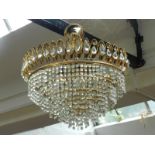 A 20th century brass drop-down chandelier, with glass droplets.