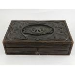 A late 19th / early 20th century carved wooden games box, containing bone counters,