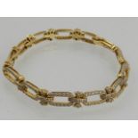 An 18 carat yellow gold and diamond articulated link bracelet, set numerous small diamonds.