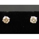 A pair of white gold and diamond stud earrings, the diamonds of approx. 0.7 carats combined.