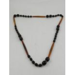 A horn beaded necklace, set oval beads interspersed with larger sections of horn.