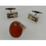 A silver and oval amber cabouchon ring, together with a pair of silver cufflinks.