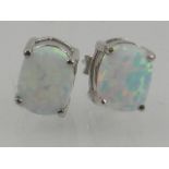 A pair of silver and opalite stud earrings.
