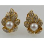 A pair of 18 carat yellow gold, diamond, and pearl set earrings.